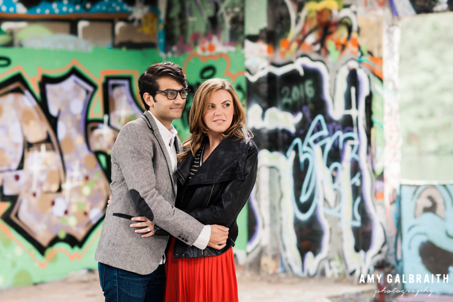 couple hugging in a graffiti colored abandoned building