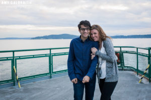 couple laughing as their ride a ferry during their engagement session