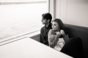 couple snuggling on the ferry ride from bainbridge to seattle
