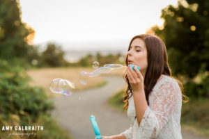 high school senior blowing bubbles
