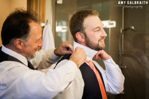 groom adjusting his collar