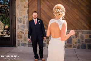groom admiring bride's gown