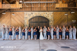 very large wedding party in navy and coral