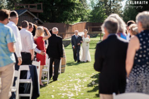 bride and her father walking down the aisle at swiftwater cellars