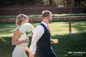 bride and groom walking with cocktails