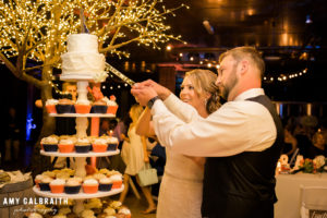 bride and groom cutting the cake at their wedding