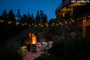 bride and groom at fire pit at swiftwater cellars with string lights