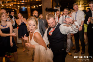 groom dancing with bride in a funny way at wedding reception