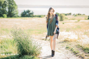 high school senior wearing short green dress on a path at discovery park