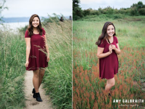 high school senior wearing maroon dress among tall grass at discovery park in seattle