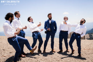 groomsmen laughing together on mountain top