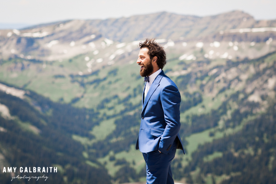 groom waiting for bride on mountain top