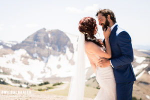bride and groom on mountain with cody peak at jackson hole