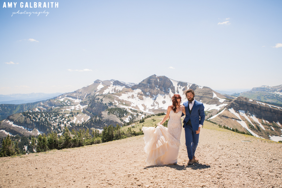 bride and groom on top of jackson hole with cody peak