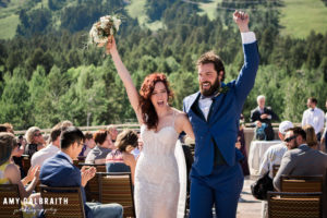 bride and groom cheering after ceremony in jackson hole