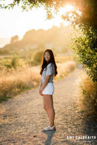 skyline high school senior on a trail at sunset at discovery park in seattle