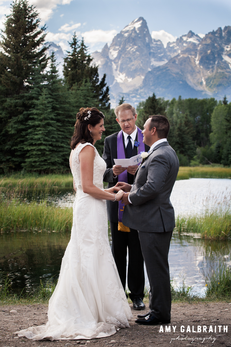Bride and groom exchange vows during their Grand Teton wedding ceremony at Schwabacher's Landing
