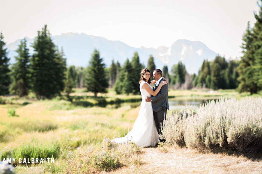 bride and groom with mt moran in the background at schwabacher's landing