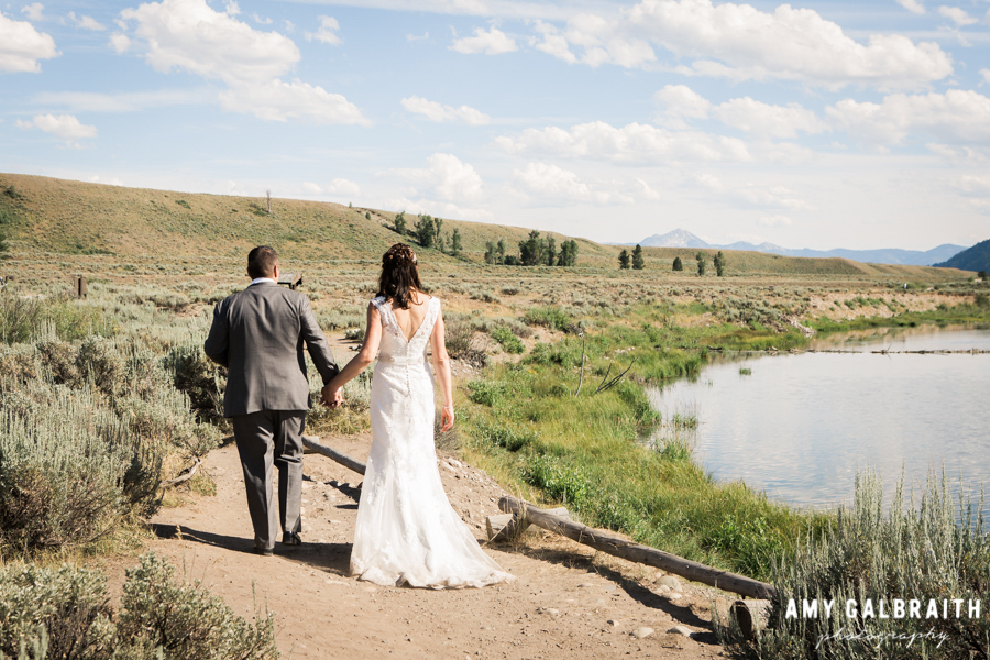 bride and groom walking along the snake river in jackson hole