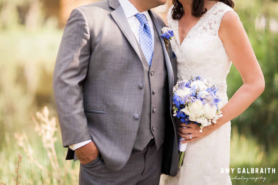purple and blue wedding flowers with grey suit