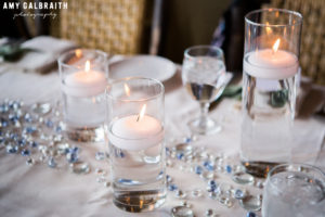candles and blue crystals on wedding reception table