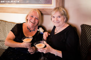 two ladies sipping espresso martinis at wedding reception