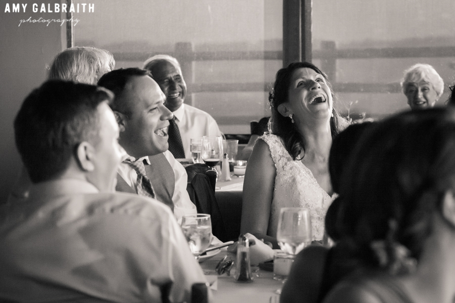 bride laughing during toast at wedding