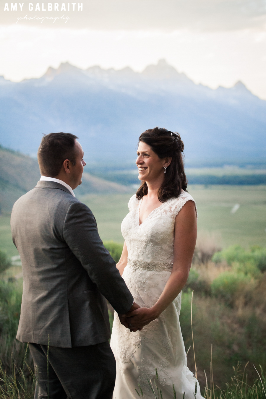 bride and groom with the Grand Tetons on their wedding day at sunset