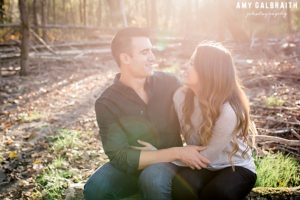 couple sitting on log near snoqualmie river