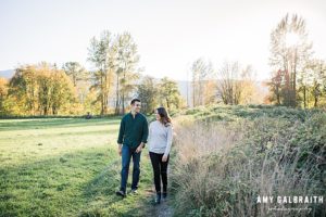 couple walking through golden fields in snoqualmie