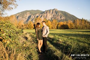 couple standing in front of mt si during snoqualmie engagement session