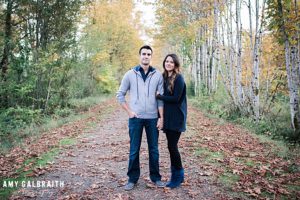 couple standing on path with fall leaves in snoqualmie
