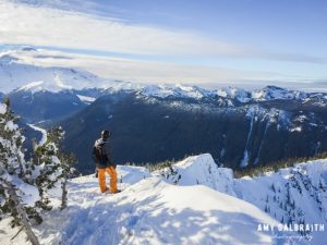 snowboarder enjoying views from the top of silver king at crystal mountain