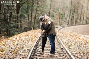a couple kissing on the railroad tracks near Stevens Pass