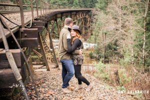 A couple standing next to the railroad at Stevens Pass