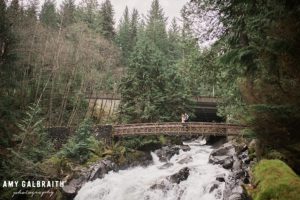 a couple on the bridge above angel falls at stevens pass