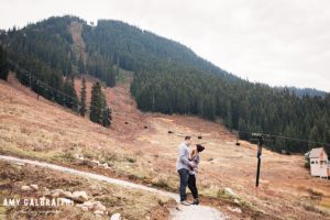 a couple standing next to big chief chairlift at stevens pass