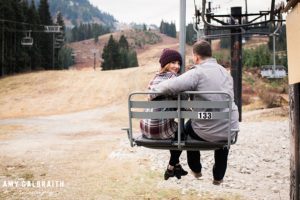 a couple sitting on the brooks chairlift during their engagement session at stevens pass washington