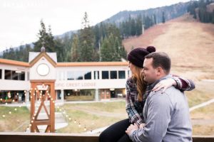 a couple sitting near the lodge at stevens pass