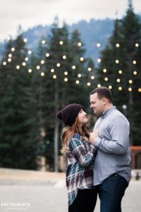 a couple having an intimate moment under the bistro lights during their stevens pass engagement session