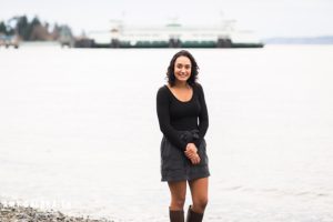 holy names senior standing in front of ferry on the beach at lincoln park