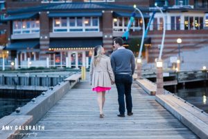 couple holding hands on the dock at carillon point