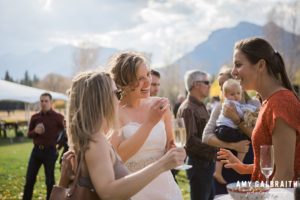 bride chats with her wedding guests during cocktail hour in jackson hole