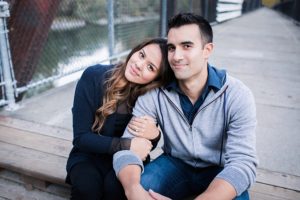 well dressed couple sitting on bridge in snoqualmie washington