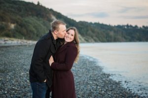 couple dressed in peacoats during engagement session at discovery park in seattle