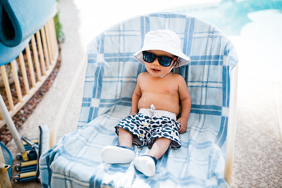 baby wearing sunglasses and board shorts
