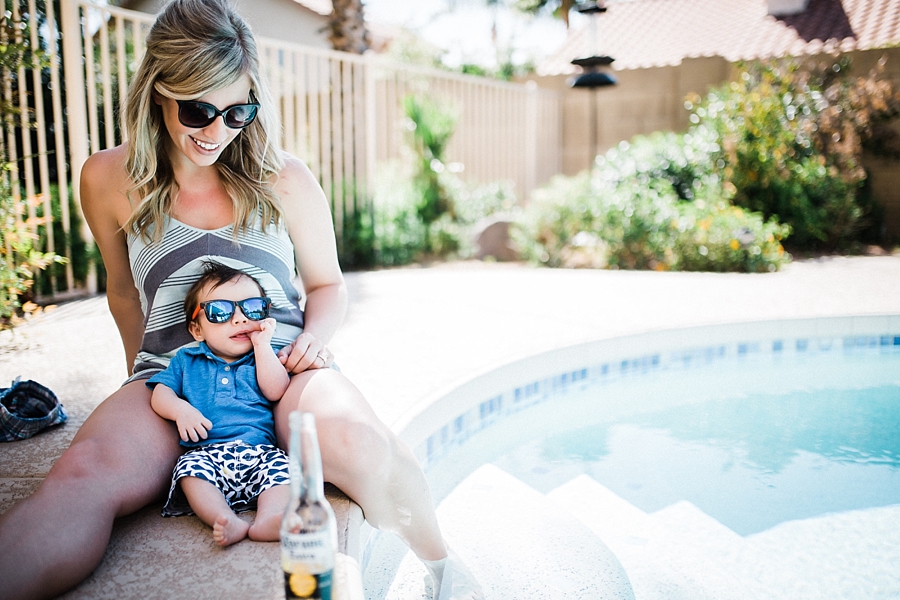 mother lounging with baby boy by the pool