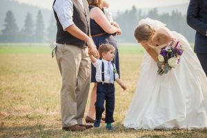 bride talking to ring bearer at wedding