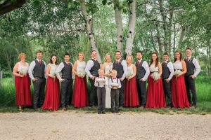 red and white wedding party in front of aspen trees