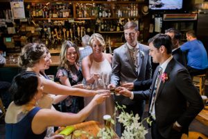 wedding party toasting drinks at the roanoke bar in seattle